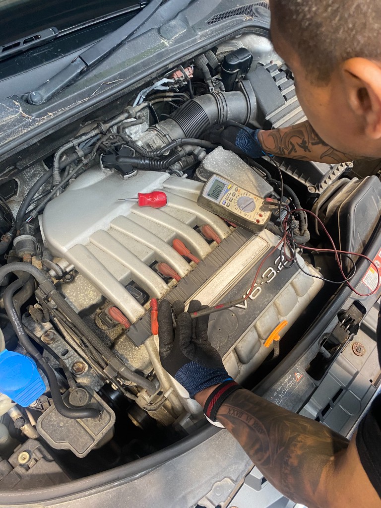 Close-up of diagnostic work on a V6 engine